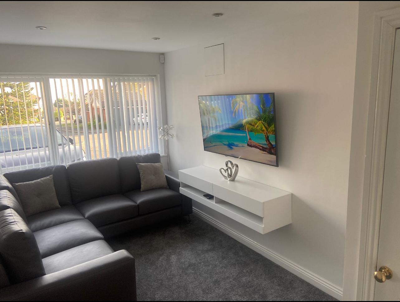 Completed Bury Garage Conversions living room with TV wall